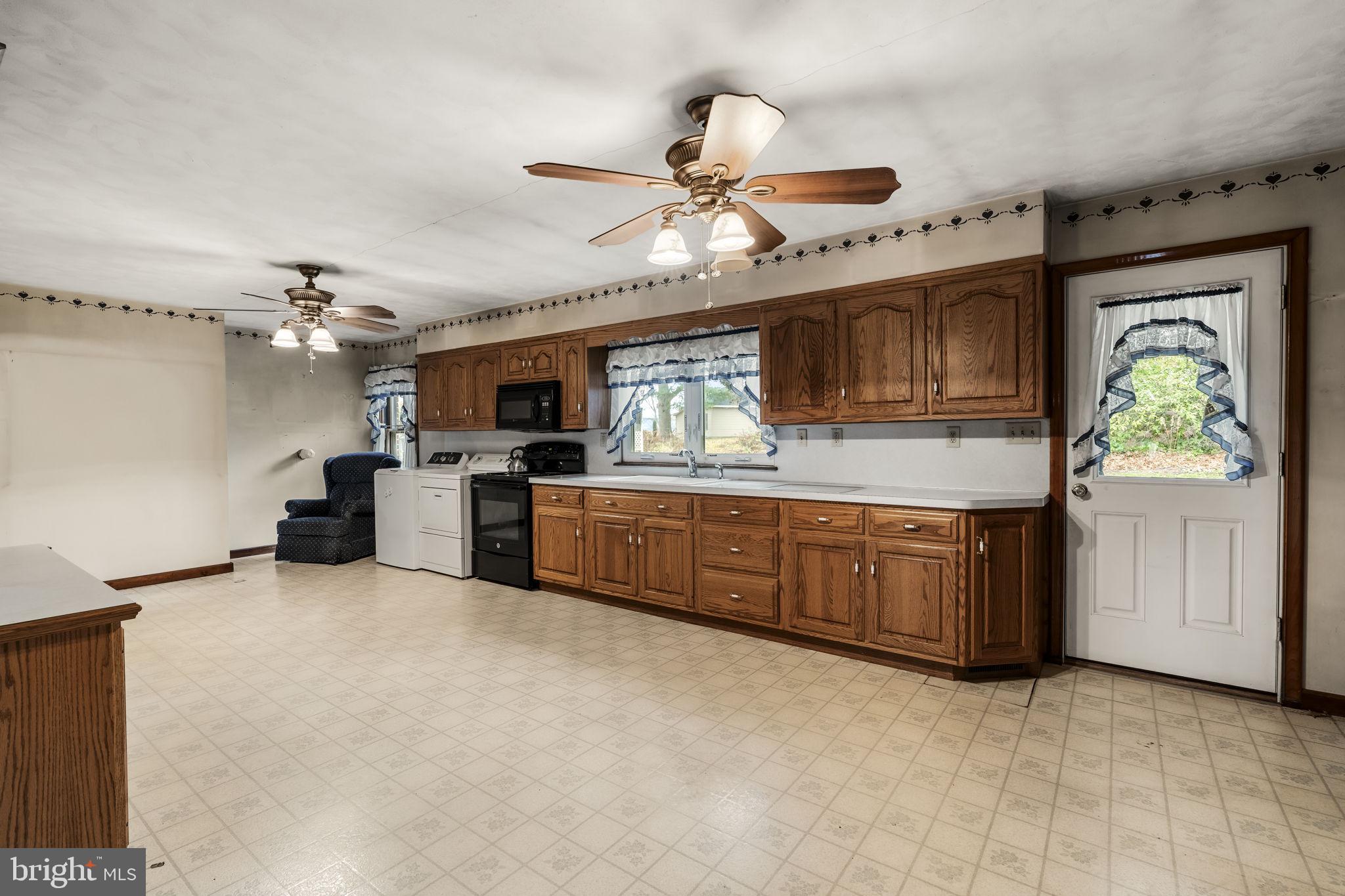 1245 West Swartzville Road Reinholds, PA 17569 - Photo 11 of 29 a kitchen with a stove a sink and a refrigerator