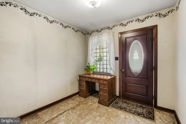 a room with painting on the wall and a window