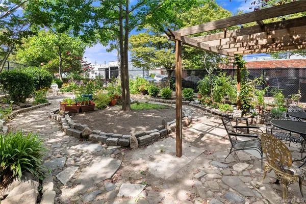 a view of a backyard with sitting area