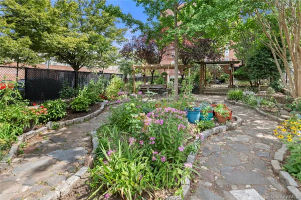 a view of a garden with flowers and trees