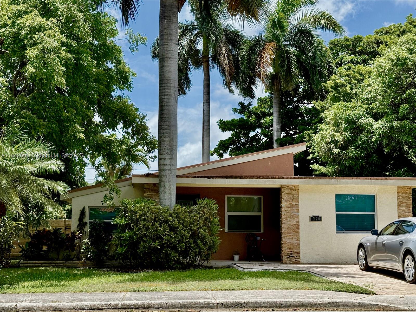 a view of a house with a yard and plants