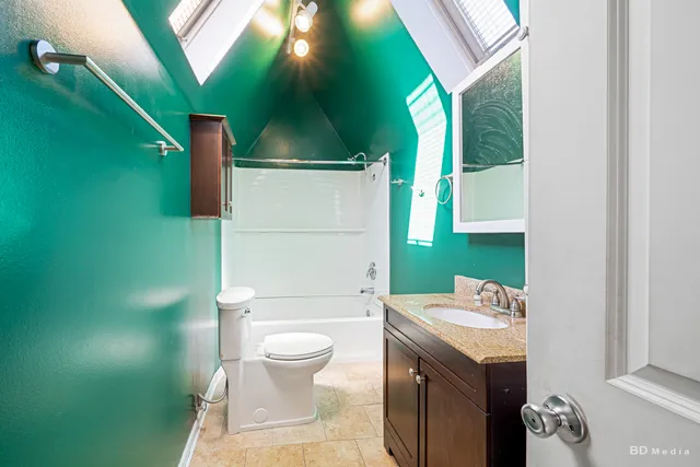 a bathroom with a toilet a sink and mirror