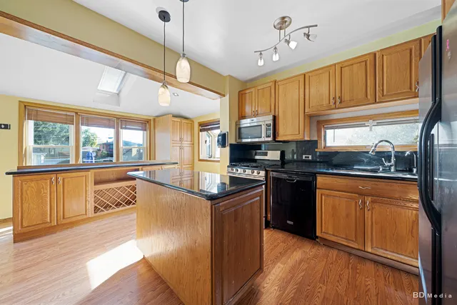 a kitchen with stainless steel appliances granite countertop a stove and a refrigerator