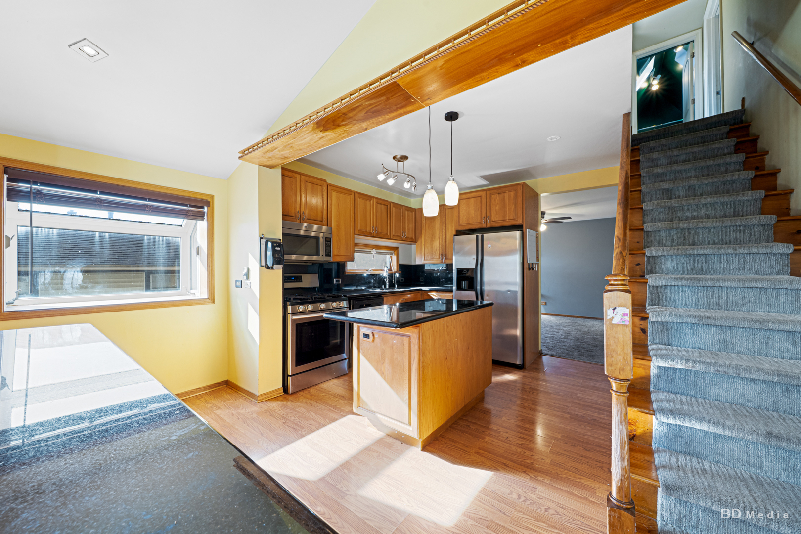 14603 Kenton Avenue Midlothian, IL 60445 - Photo 9 of 17 a kitchen with stainless steel appliances kitchen island granite countertop a refrigerator a stove and a wooden cabinets