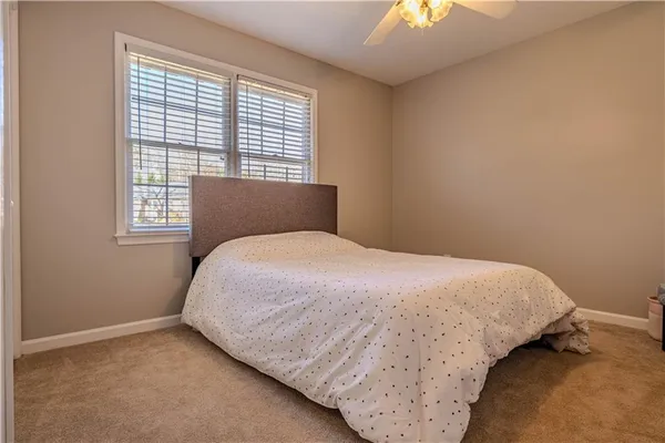 a bed sitting in a bedroom next to a window