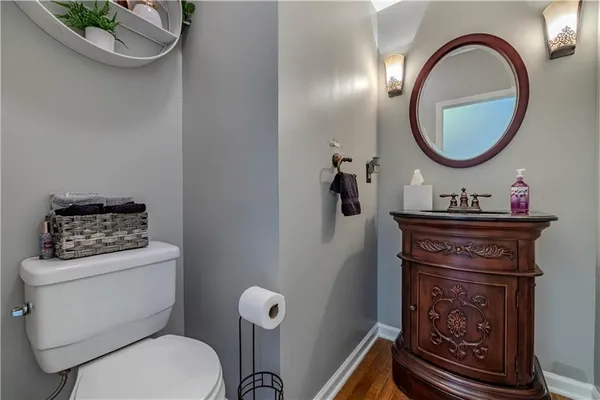 a bathroom with a toilet a sink and a mirror