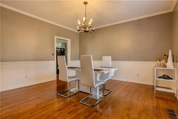 a view of a workspace with furniture and wooden floor