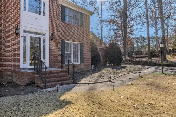 a view of a house with a yard covered in snow