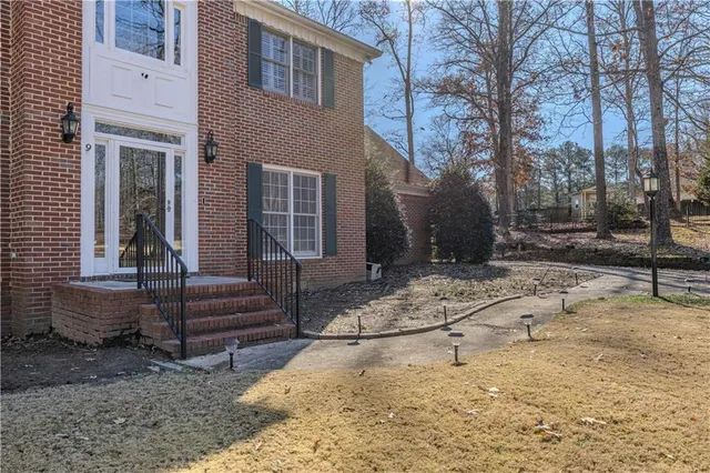 a view of a house with a yard covered in snow