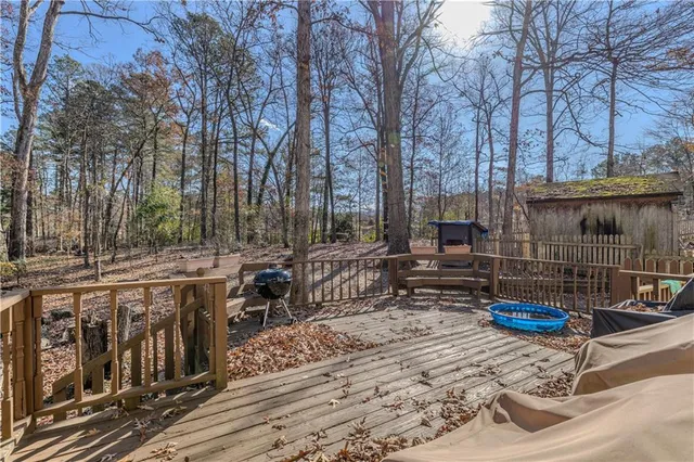 a backyard of a house with barbeque oven table and chairs