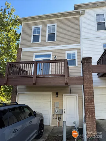 a view of a patio with a table and chairs and potted plants