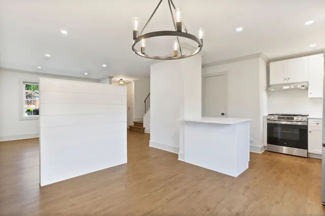 a kitchen with a refrigerator and a stove top oven