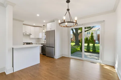 a kitchen with stainless steel appliances granite countertop a refrigerator and a stove top oven