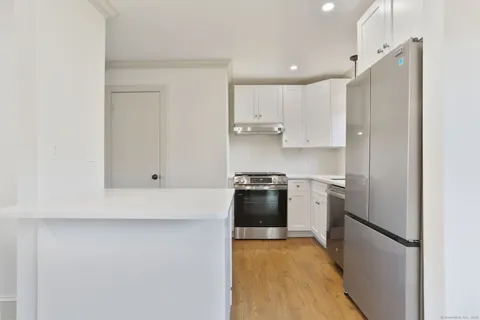 a kitchen with stainless steel appliances a refrigerator stove and microwave