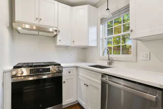 a kitchen with a sink stove and cabinets
