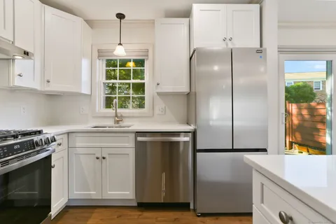 a kitchen with a refrigerator and window