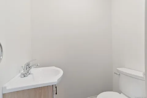a bathroom with a sink a toilet and mirror