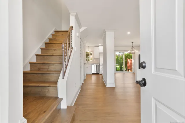 a view of an entryway with wooden floor