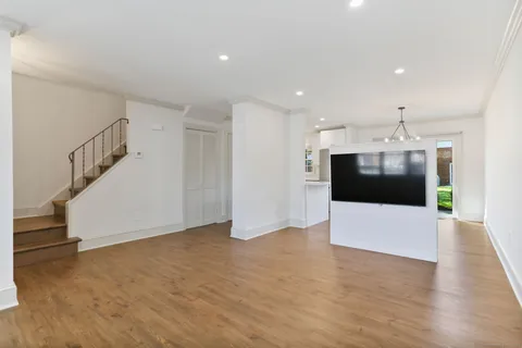 a view of a kitchen with a dishwasher and white cabinets