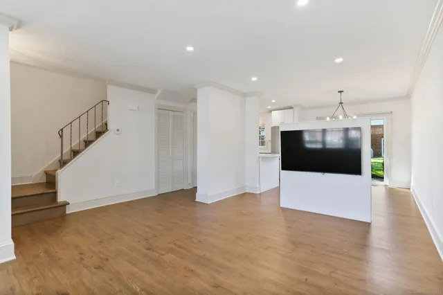 a view of a kitchen with a dishwasher and white cabinets
