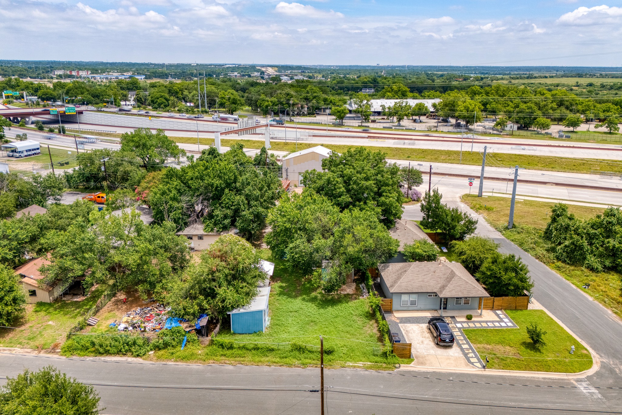 6409 Del Monte Road Austin, TX 78741 - Photo 14 of 15 An aerial perspective reveals a cozy dwelling nestled beside a vibrant green lawn and a paved driveway.