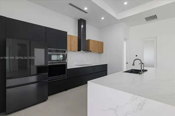 a kitchen with a refrigerator and a sink