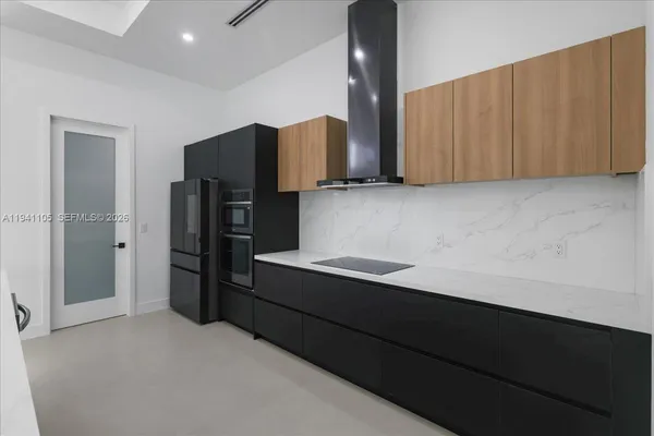 a kitchen with cabinets and stainless steel appliances