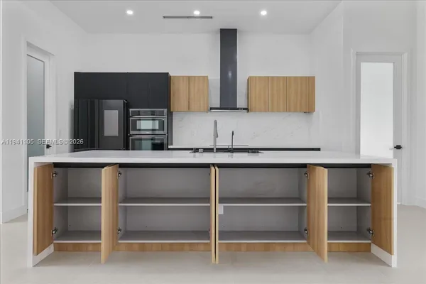 a kitchen with cabinets and white appliances