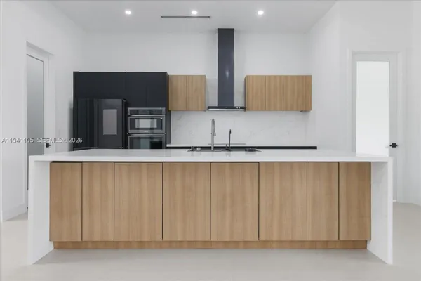 a kitchen with stainless steel appliances a refrigerator and a stove