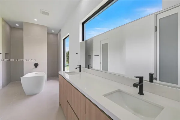 a bathroom with a sink and a large mirror