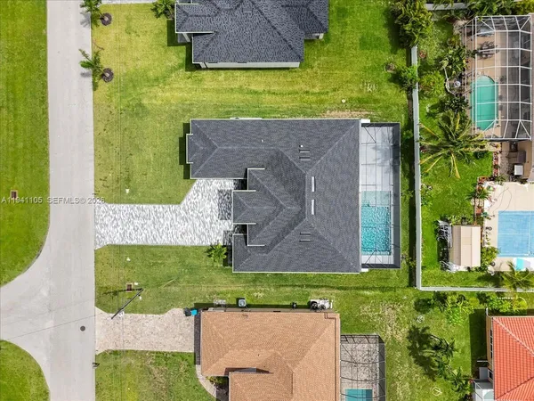 an aerial view of a house with a yard