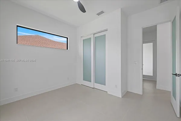 a bathroom with a granite countertop sink a toilet and a mirror