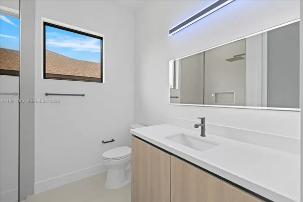 a bathroom with a glass shower door