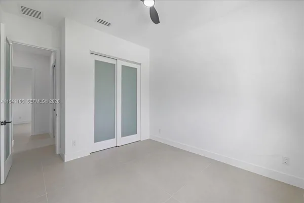 a view of a big room with closet and windows