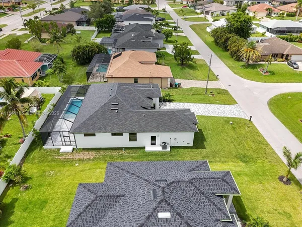 an aerial view of a house with a swimming pool