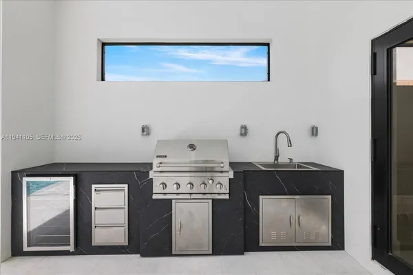 a view of house with backyard porch and glass doors