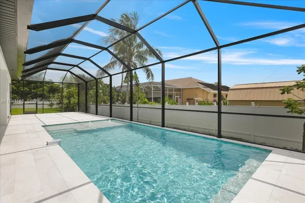 a view of a house with a yard and potted plants