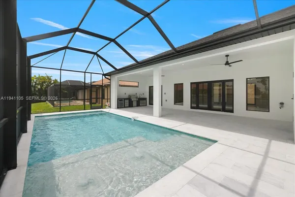 an aerial view of a house with a garden and lake view