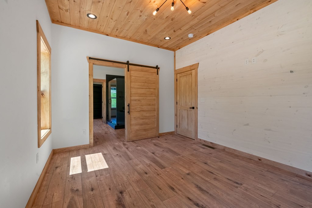 168 Ewing Street Blue Ridge, GA 30513 - Photo 33 of 46 wooden floor in an empty room with a window
