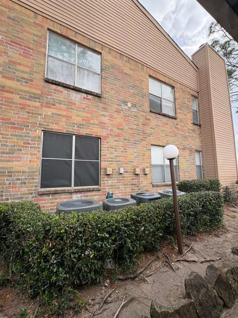 10555 Turtlewood Court, Unit 1511 Houston, TX 77072 - Photo 16 of 23 a front view of a house with a garden