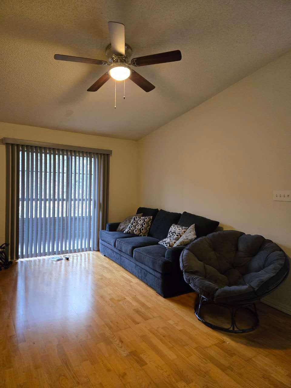10555 Turtlewood Court, Unit 1511 Houston, TX 77072 - Photo 20 of 23 a living room with furniture and a ceiling fan