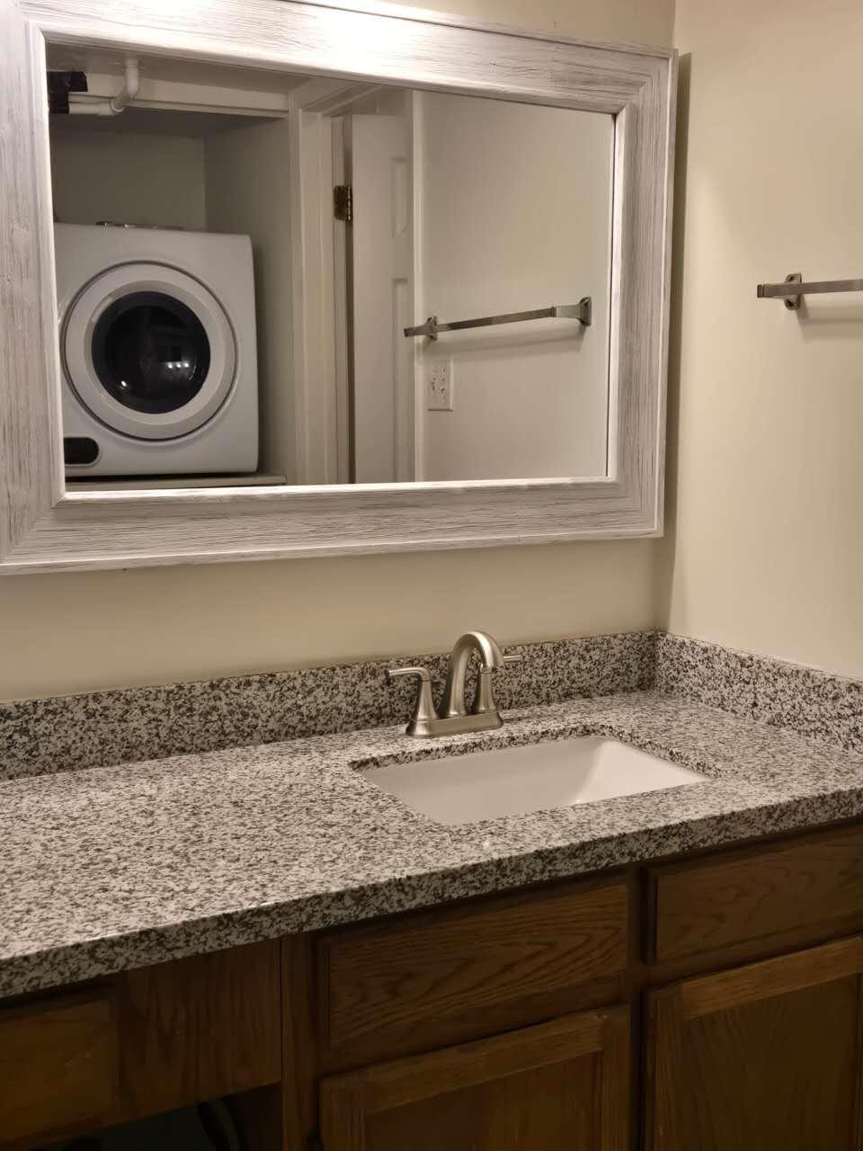 10555 Turtlewood Court, Unit 1511 Houston, TX 77072 - Photo 22 of 23 a bathroom with a granite countertop sink a mirror and vanity