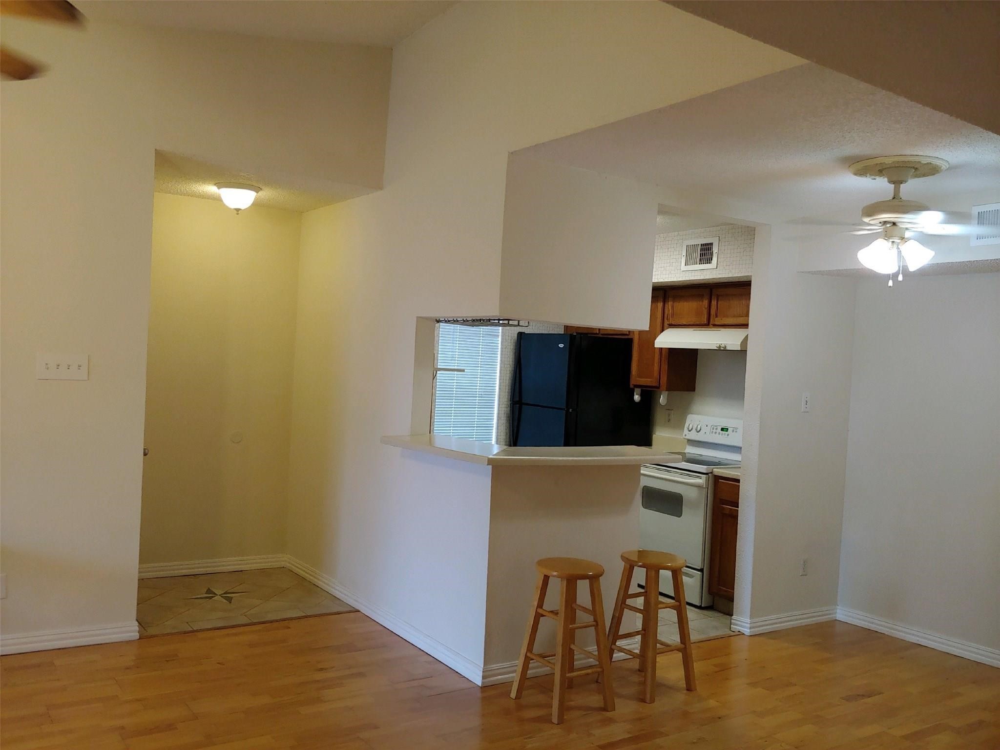 10555 Turtlewood Court, Unit 1511 Houston, TX 77072 - Photo 4 of 23 a workspace with furniture and wooden floor