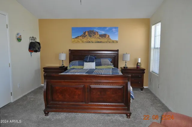 a bathroom with a granite countertop sink a toilet and a mirror
