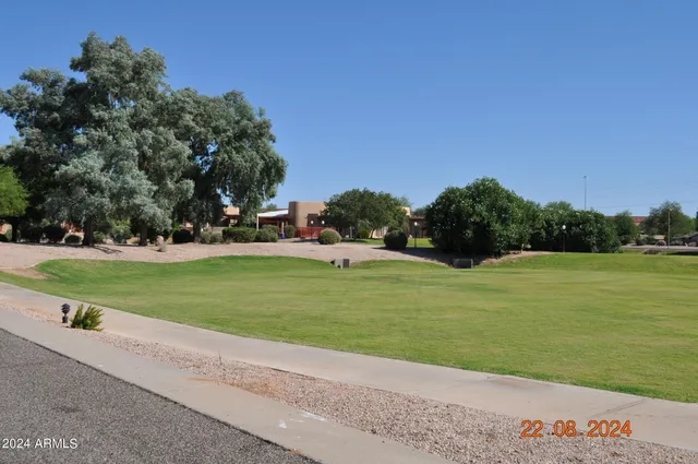 a living room with a table chairs and chandelier