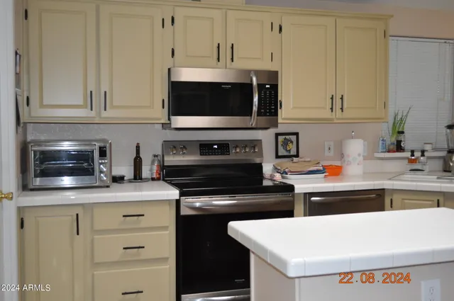 a kitchen with stainless steel appliances a refrigerator stove and sink