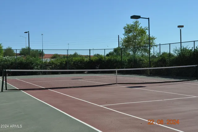 a dining room with furniture and a floor to ceiling window