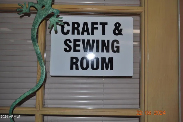 a view of a patio with lawn chairs floor to ceiling window and an outdoor kitchen