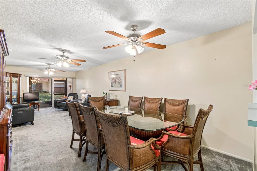 11340 Carriage Hill Drive, Unit 4 Port Richey, FL 34668 - Photo 3 of 36 a view of a dining room with furniture