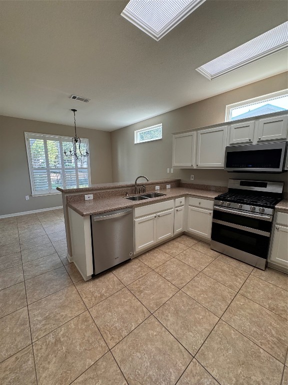 127 Verbena Drive Georgetown, TX 78633 - Photo 11 of 12 a kitchen with stainless steel appliances granite countertop a sink cabinets and a counter top space
